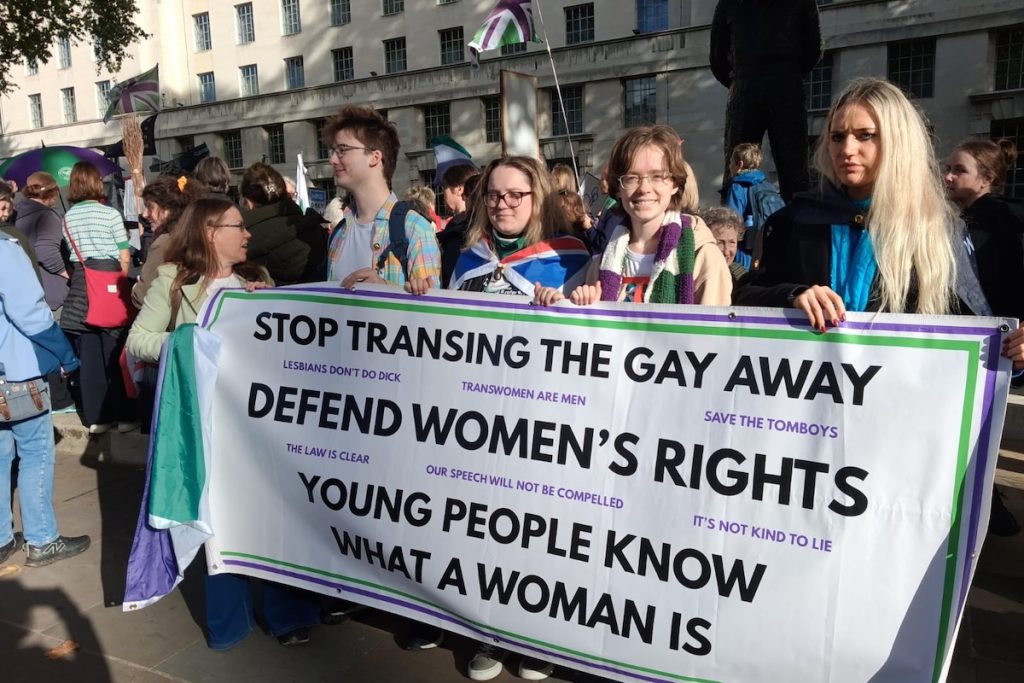 Stop transing the gay away sign held by a group of young activists at the 199 days march