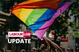 people holding a rainbow flag on a march